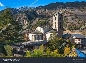 stock-photo-beautiful-th-century-stone-st-esteve-church-surrounded-by-green-trees-with-pyrenees-mountains-2255320195-1